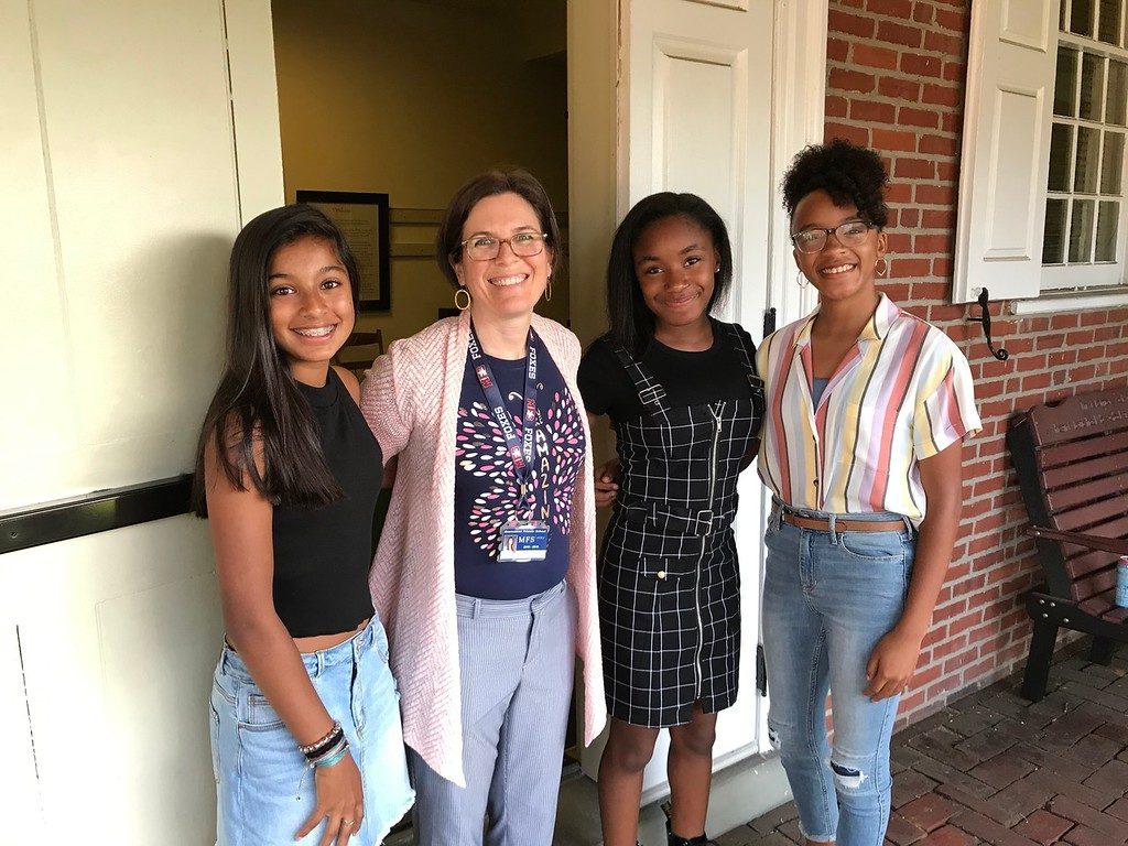 Clarkson poses with middle school students outside the Meeting House before Meeting for Worship. 