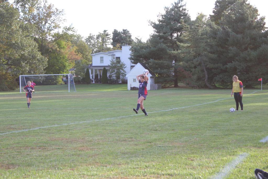 Roni Kennedy '22 prepares to throw the ball in during the Foxes’ thrilling late game victory against George School (Photo via Rebecca Benjamin‘’21). 
