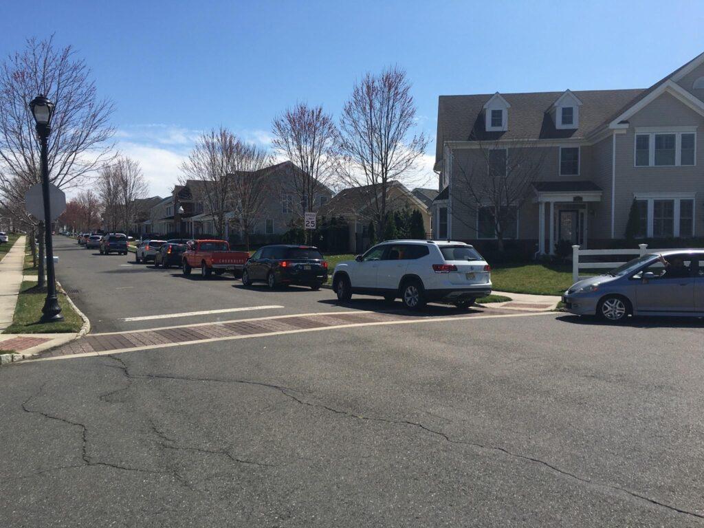 Photo by Emma Nei ’22. Cars are lined up for a drive-by birthday celebration.