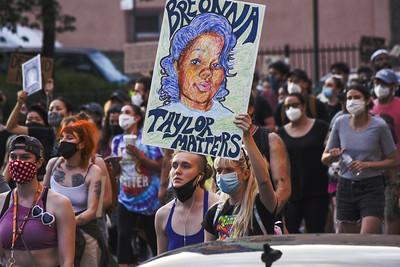 Courtesy of Informed Images 
Protesters hold up signs demanding justice for Breonna Taylor
