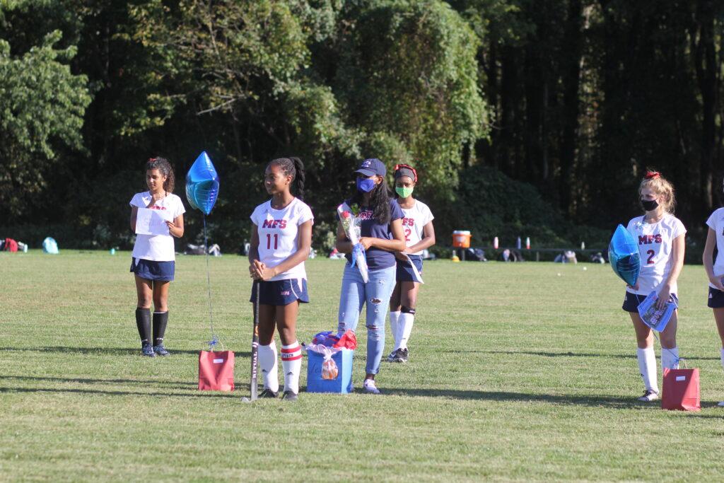 Senior members of the girls field hockey team celebrate senior night. (Photo by Rebecca Benjamin ’21)