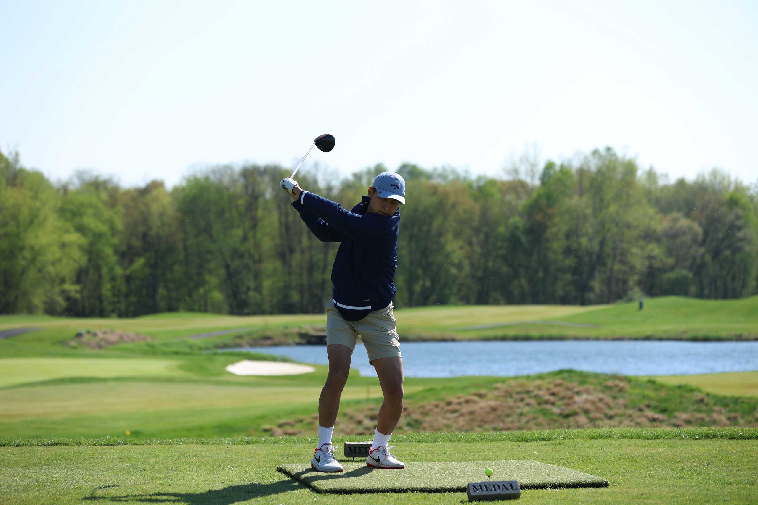 Alex Kwak ‘23 at the tee winding up with his driver. Photo from MFS Smugmug.
