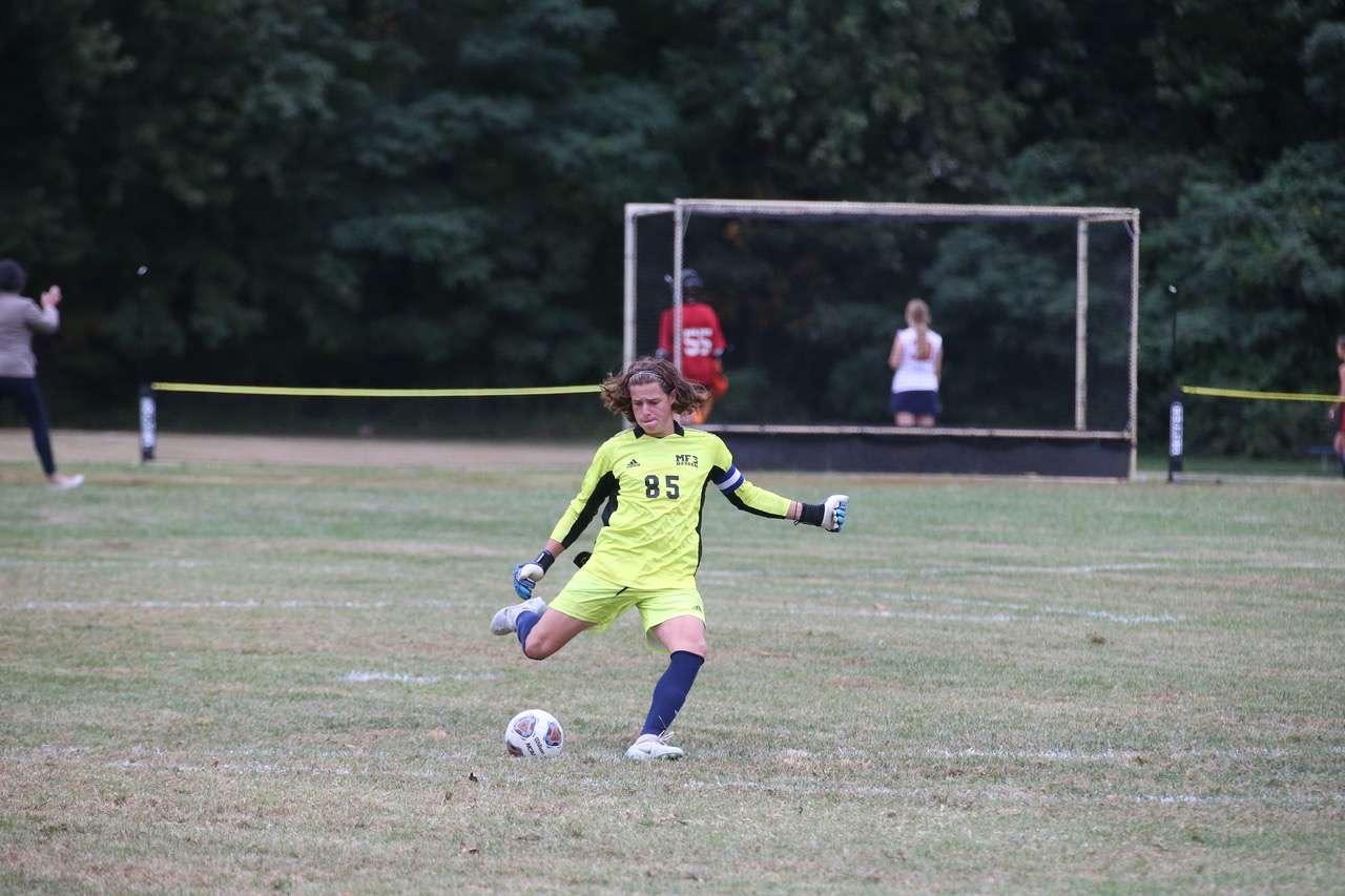 Jonah Bierig kicks a ball across the pitch in a game in Fall of 2022. Taken by Dinah Megibow-Taylor '24.