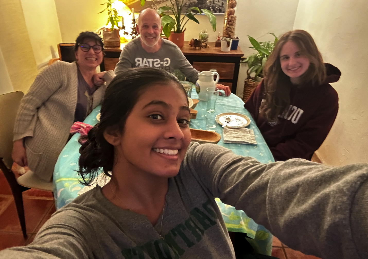 Nathalie, Christophe, my homestay partner Elina Shah ’24, and me enjoying our final dinner.
