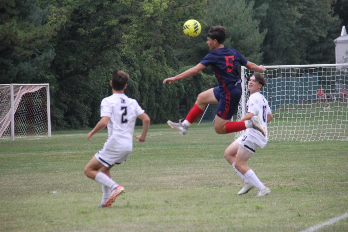 Alex Kostopoulos '26 goes airborne playing soccer. Photo by Matt Strauss '27.