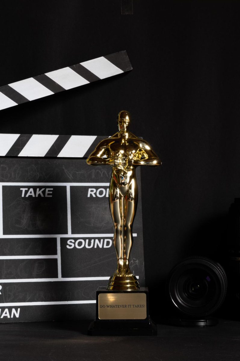 Academy award in front of clapper board. From Mirko Fabian on Unsplash. 
