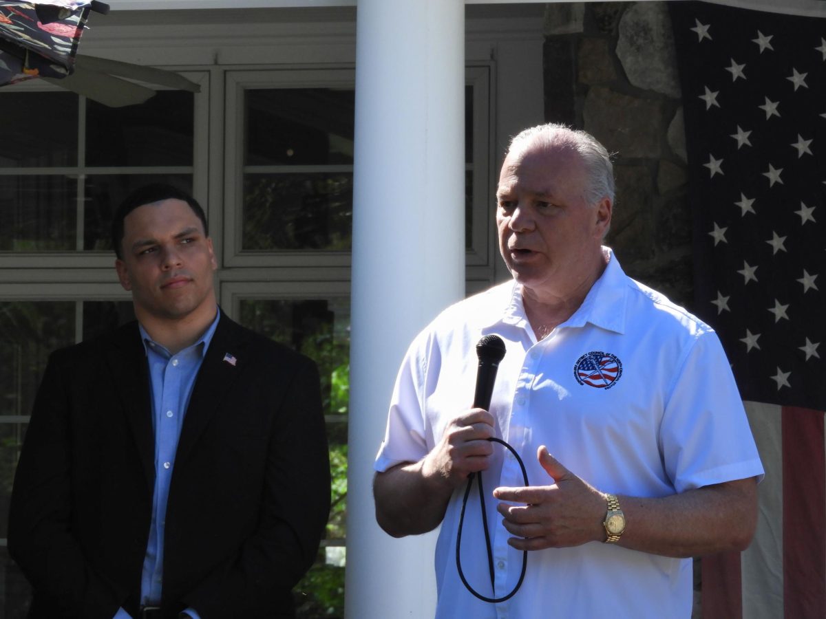 Steve Sweeny (right) delivering a speech at the home of Paul Riggens in Moorestown next to Moorestown Mayor Quinton Law (left). Photo by Chloe Marshall ’26.