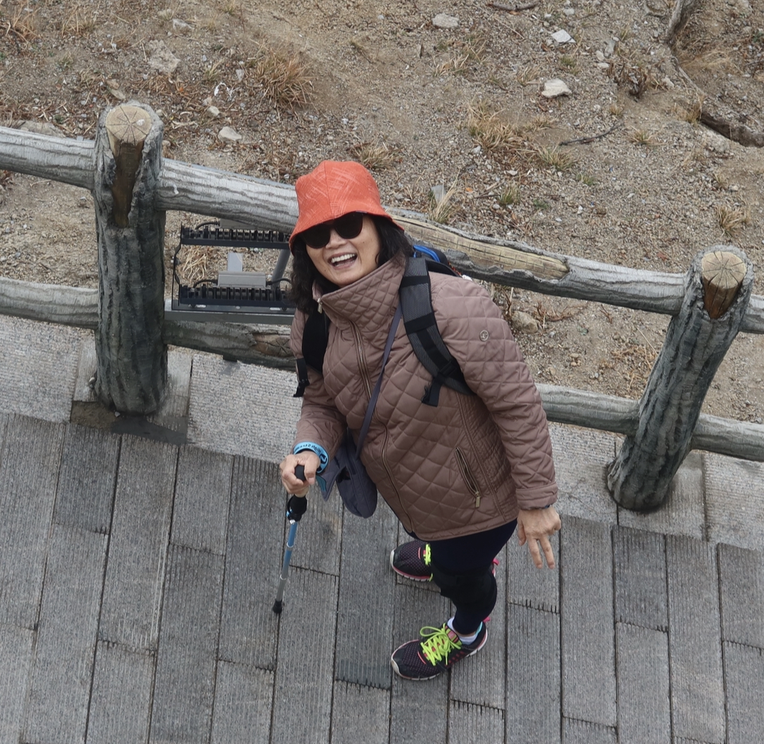 Cathy Wang smiling while walking up the Great Wall of China during the 2024 China Intensive Learning trip. Photo by Sarah Huynh ’25.