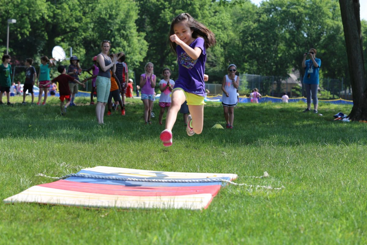 Livia Kam ’26 jumping across two ropes during Lower School Fun Day in 2016. Photo from MFS SmugMug.