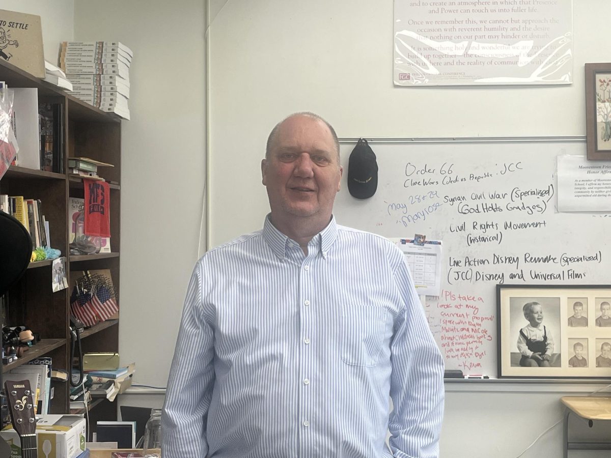Clark Thomson, Model UN Adviser, poses in his classroom. Photo by Keva Elie '26.