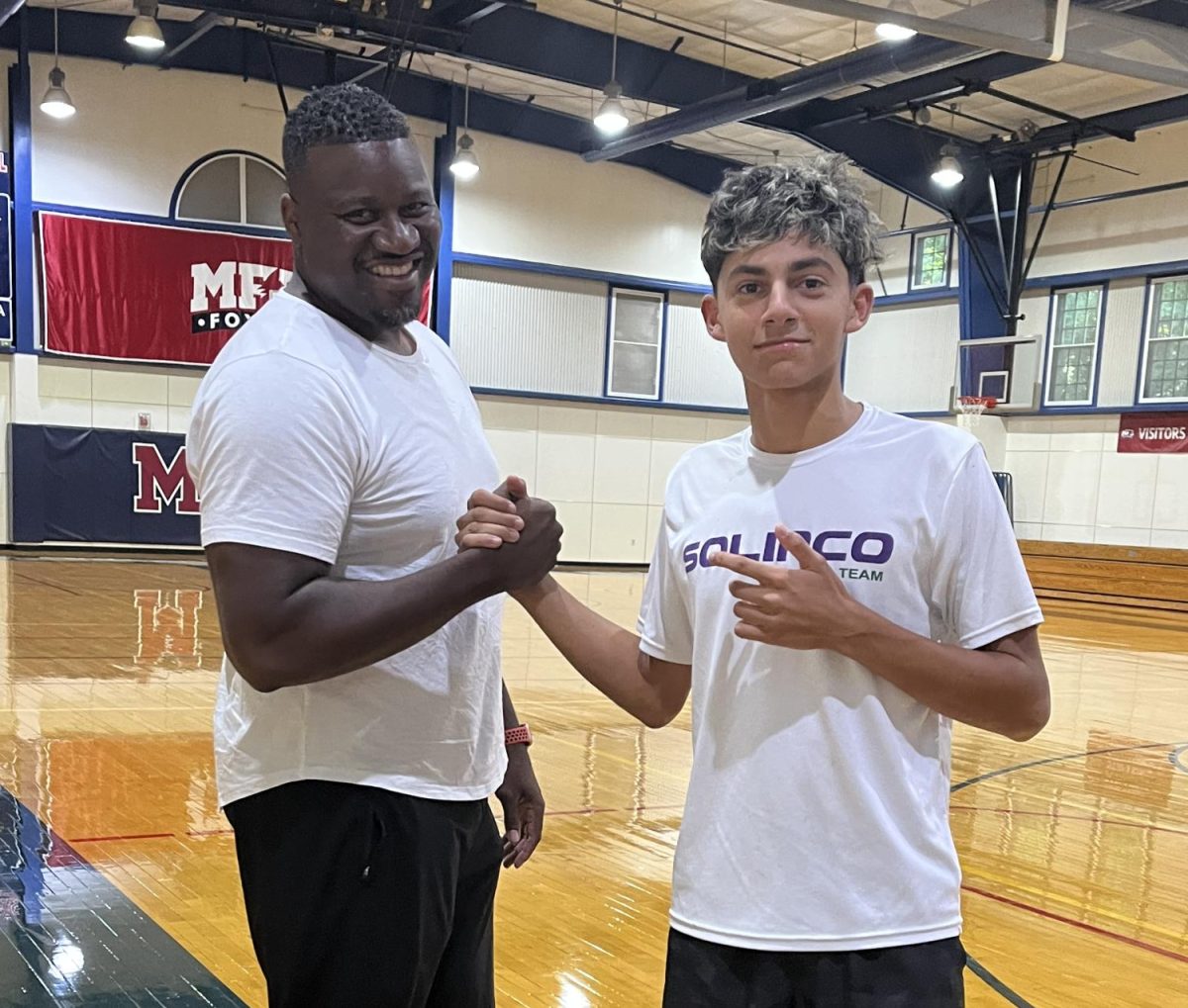 Coach Nathaniel Henderson and Student Rafael Rauf '27 before training. Photo by Liva Kam '26.