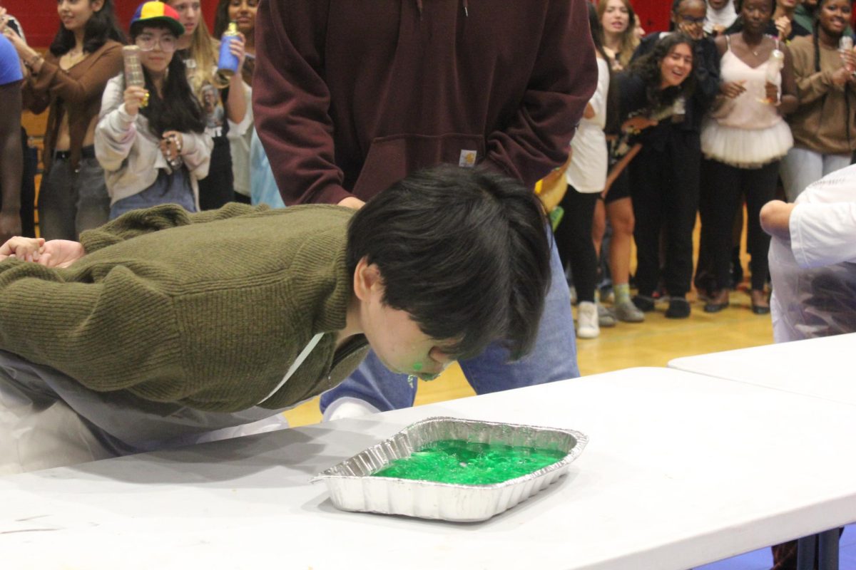 Allan Gu '27 consumes jello for the Jello Eating Contest. Photo by Emmie Huynh '27.