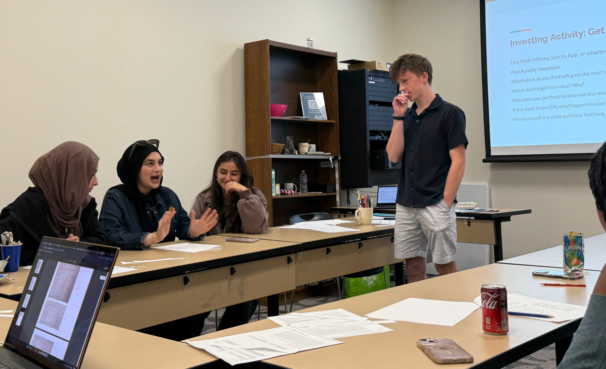 Matthew Conner '26 teaches a financial literacy course to a group of students at the Moorestown Library. Photo by Meredith Godley.
