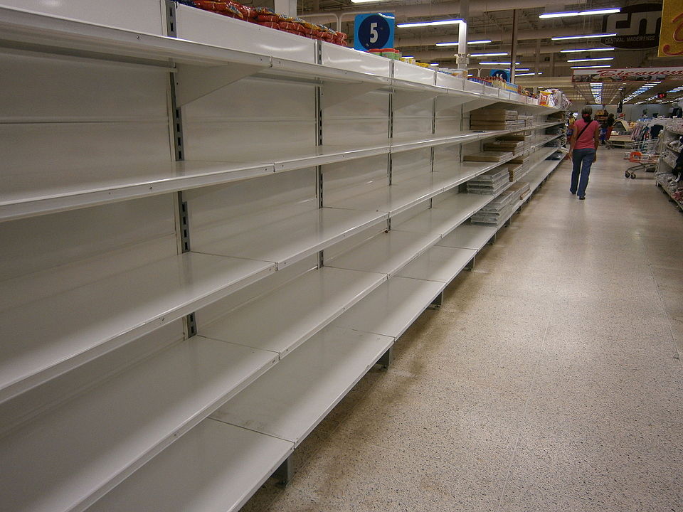 Empty shelves in a Venezuelan government-run grocery store. Mayor-elect Mamdani plans to create government-run grocery stores throughout New York City.

Photo Credit: Escasez en Venezuela, Central Madeirense. Taken by “Wilfredor” on Wikimedia Commons
