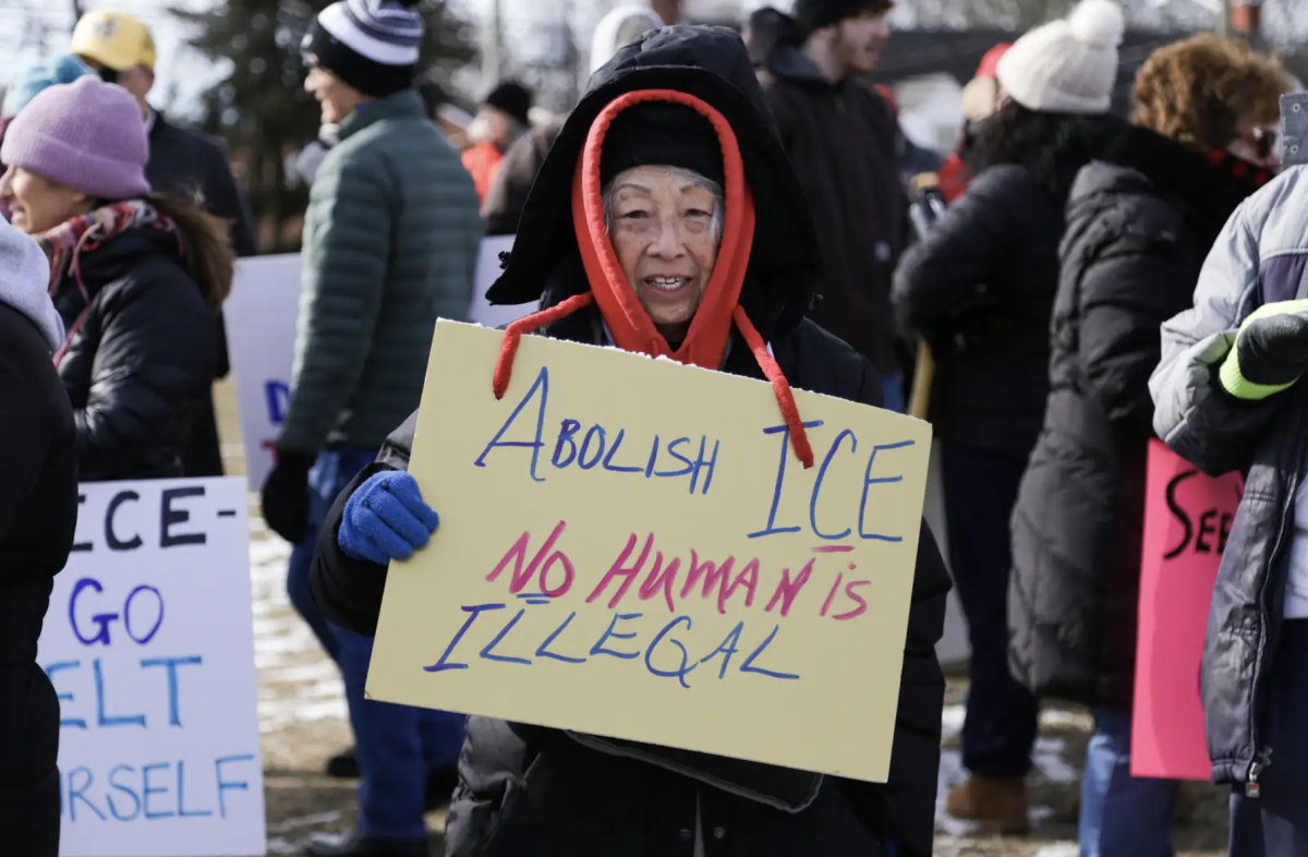 ​​A protester poses for a photo with her sign calling for the abolition of ICE. Photo courtesy of Finn Waldorf '26, student from Lenape High School. 
