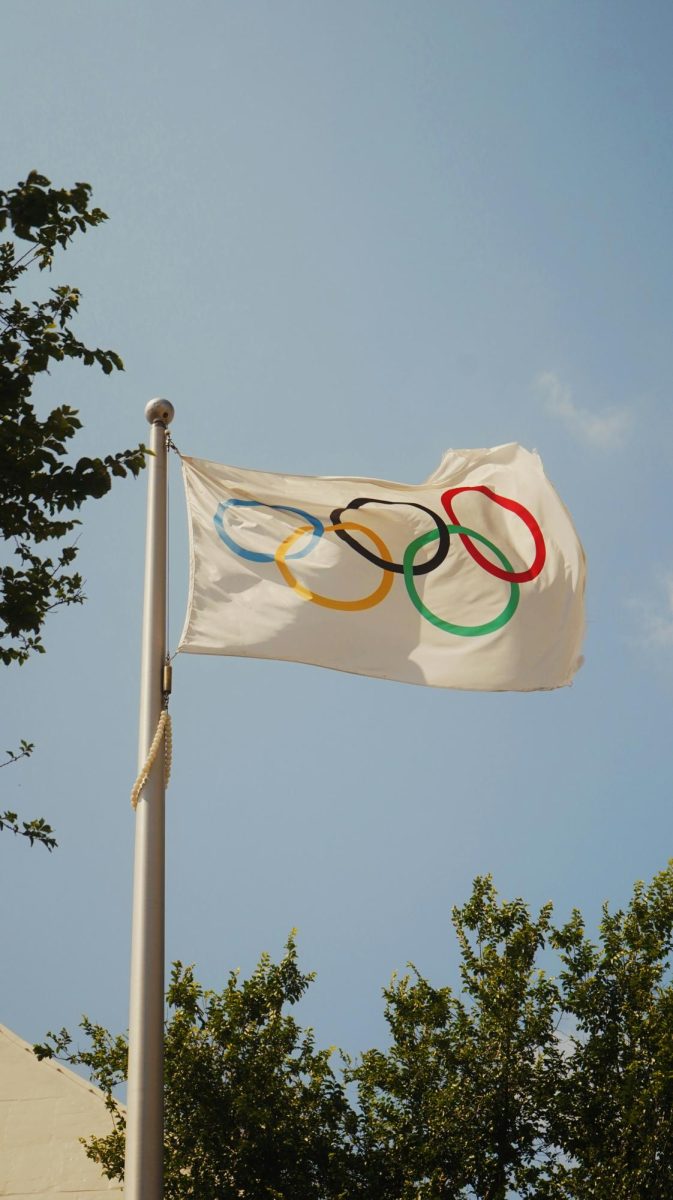 “Olympic flag waving in the wind.” Photo from Unsplash