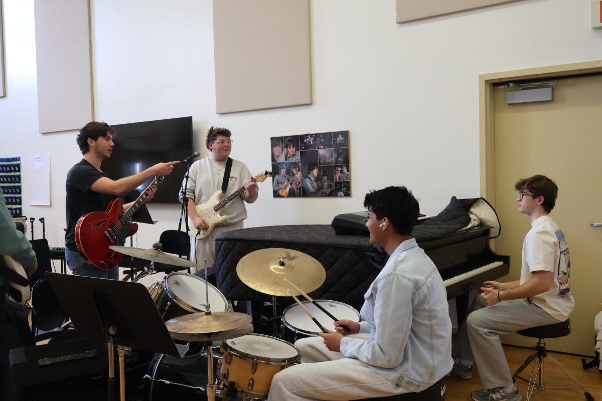 The popular music ensemble rehearses during their class meeting. Photo by Erika Capella ’27.