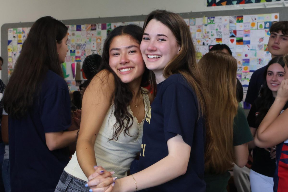 Chloe Marshall '26 and Erika Capella '27 holding hands and crying during senior countdown. Photo taken by Bersu Ozbay '28.