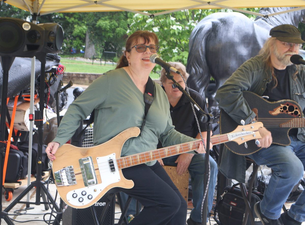 Musician at Moorestown Porch Fest playing her his guitar for the lively crowd. Photo by Meena Rajan ’29.